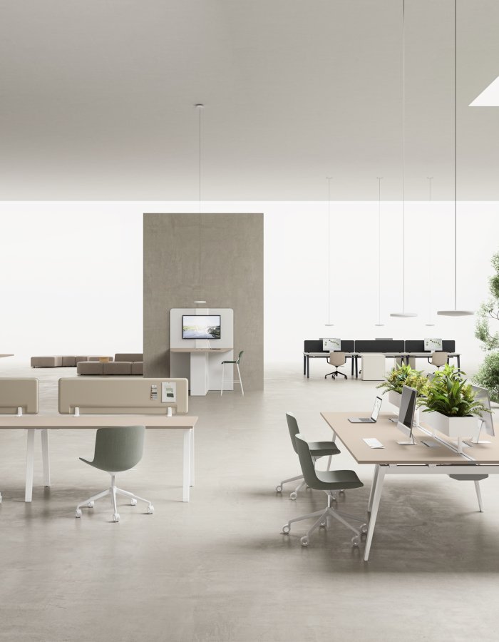 Bright break area and open plan with DVO E-Place desks, sage chairs and planters