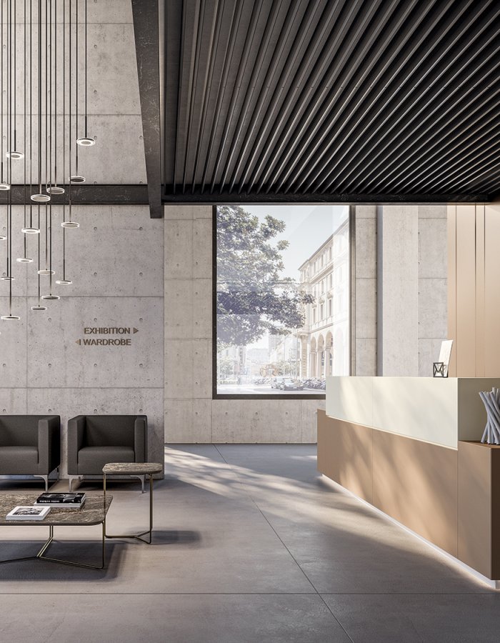 Reception lobby with Quadrifoglio Z1 desk lit at the base, lounge armchairs and marble tables