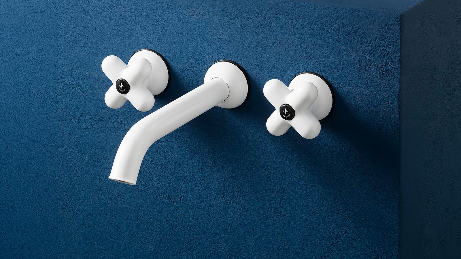 Fantini I Balocchi three-hole basin set in red and chrome on a blue basin