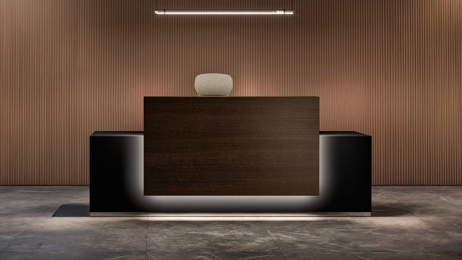 Lux reception counter by Bralco with perimeter LED light switched on