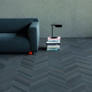 Mutina Mews porcelain floor in Ink laid in herringbone across a client reception