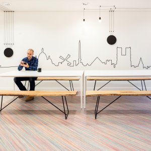 Home office with an Arper Nuur table and a laptop