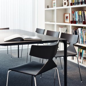 Saya chair by Arper paired with a solid wood table