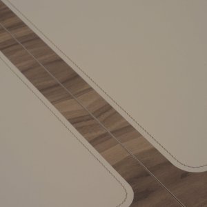 Saddle leather insert flush-mounted in the wooden top