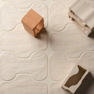 Irregular edges of a Faces & Figures tile up close