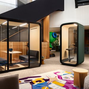 Two facing sofas and birch table inside Framery Four