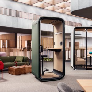 Framery One Compact booth between desks in a modern workplace