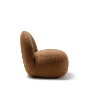 Writing table with a round wooden top next to the Hill armchair