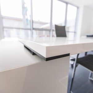 Dark brown elm laminate desktop of the New Loop executive desk