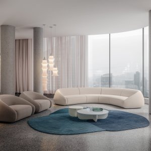 Side view of the Apper armchair, the low back curving round into the arm