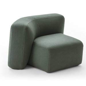 Suiseki armchair beside a low table in a lounge