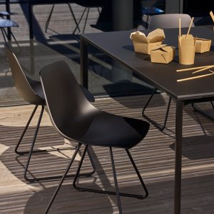 Miunn stools lined along a bar counter