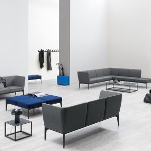 Social sofa with armrest at one end in an airport lounge