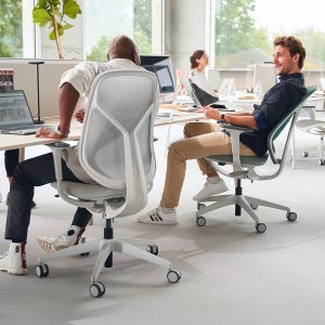 Task office chairs se:kit with sage upholstered backs around a six-seat bench