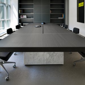 Black lacquered cabinet under a dark oak top on the Asymmetrical desk