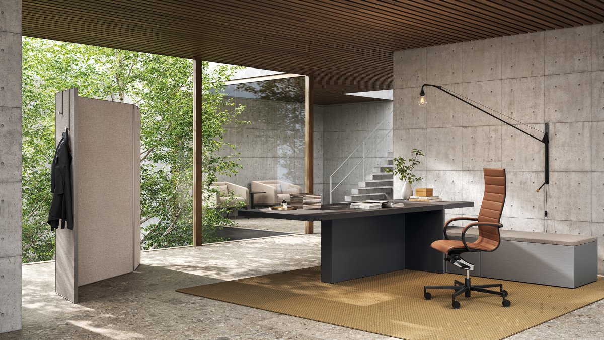 Frezza Mux70 executive desk with a tan leather chair in an office of concrete and wood