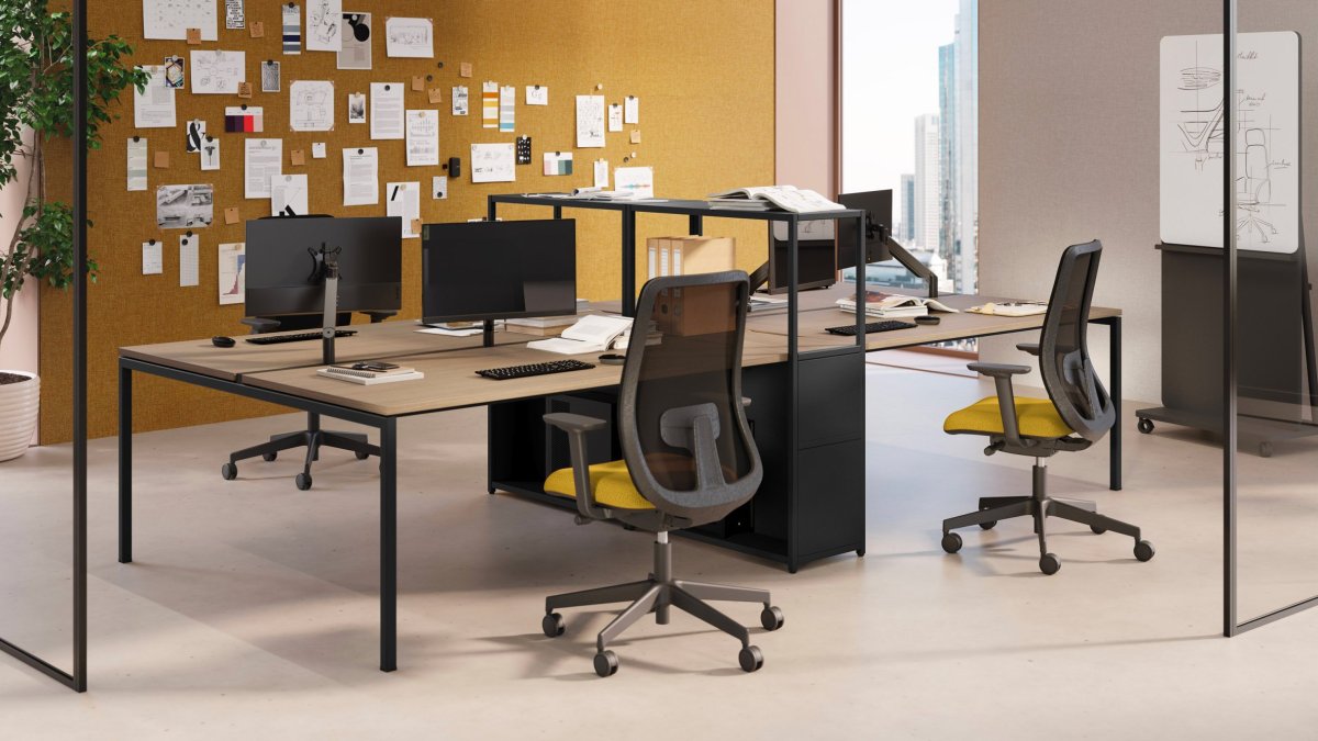 Facing Las Mobili Sigma workstations with mesh task chairs, yellow seats and a cork pinboard wall