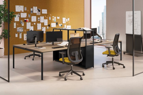 Facing Las Mobili Sigma workstations with mesh task chairs, yellow seats and a cork pinboard wall