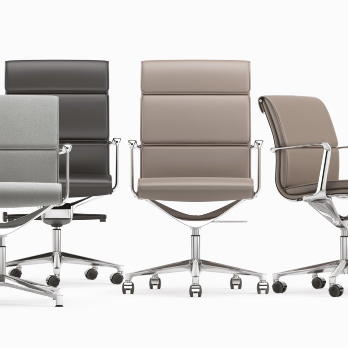 High-back Italian leather executive chair behind a director's desk in a London office, soft daylight from sash windows